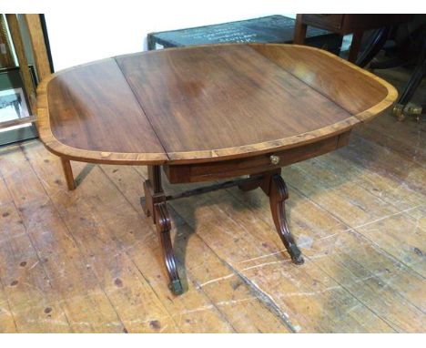 A Georgian inspired drop leaf mahogany occasional table, with walnut crossbanding, the table of tablet form when open, fitted