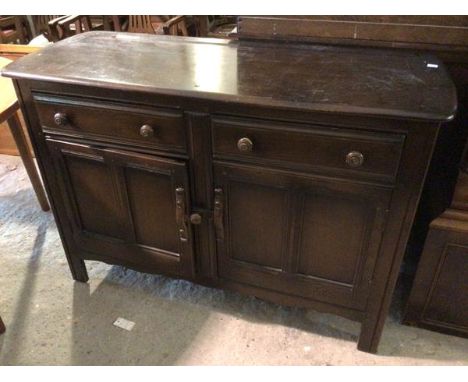 A 1930s/40s dresser base, with two frieze drawers above a single recess with shelf enclosed within two doors, on bracket feet