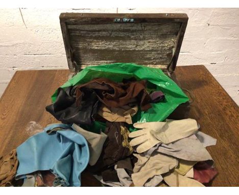 An assortment of gloves and leather offcuts in vintage box with brass handles and inscribed N to either side (box: 23cm x 54c