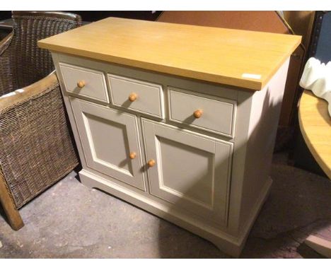 A Laura Ashley side cabinet with oak top above painted base with three frieze drawers above cabinet doors, each with one shel