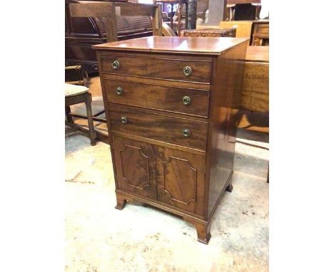 A 19thc side cabinet, the top with moulded edge above three graduated drawers and a pair of panel doors, on moulded bracket f