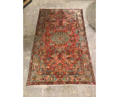 A hamadan rug, with central floral medallion surrounded by foliate design, within a light blue and multiple flowerhead border