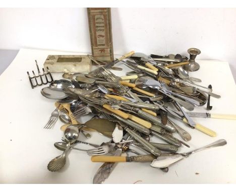 A large quantity of Epns including forks, knives, candleholders, caddy spoons, toast rack, sugar nips etc. (a lot)