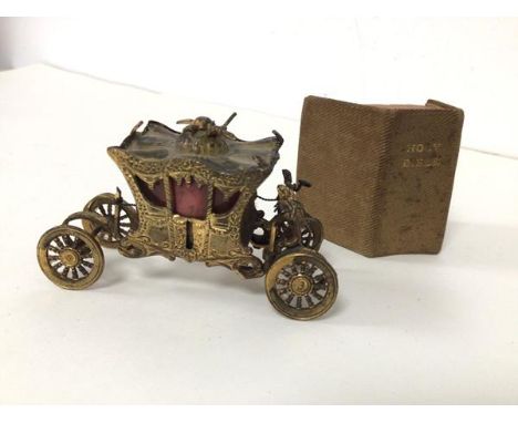 A miniature model of The Gold State Coach (4cm x 7cm x 3cm) (losses) and a miniature holy Bible (2)