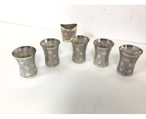 A set of five Indian white metal cups, each with a flared rim and foliate engraved body (6cm x 5cm) and a plated small vase w