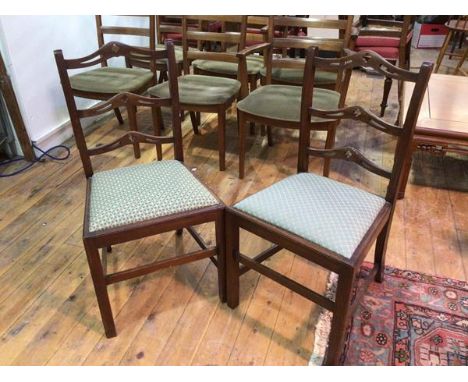 A pair of early 20thc side chairs with pierced yoke ladder backs and upholstered drop in seats, on straight front supports un