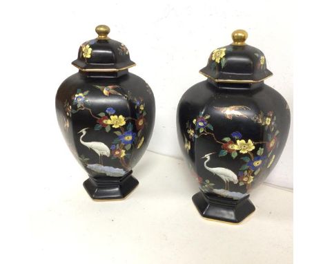 A pair of early 20thc Carltonware footed jars with lids, both decorated with flowers and birds, stamped Carlton Cloisonne war