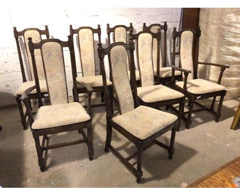 A set of eight Ercol dining chairs with curved upholstered splats above cushion pads on slats, on turned supports united by s