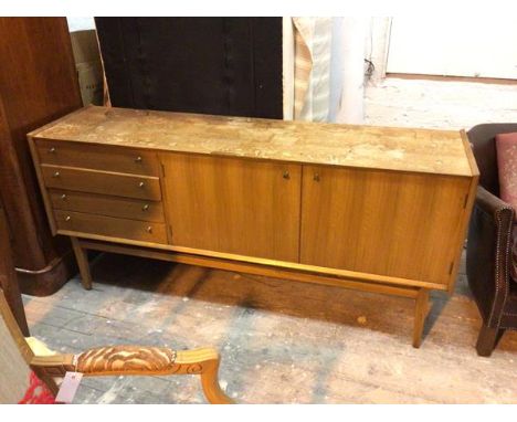 A teak mid century sideboard, with distressed top above four short drawers and two cabinet doors with single shelf to interio