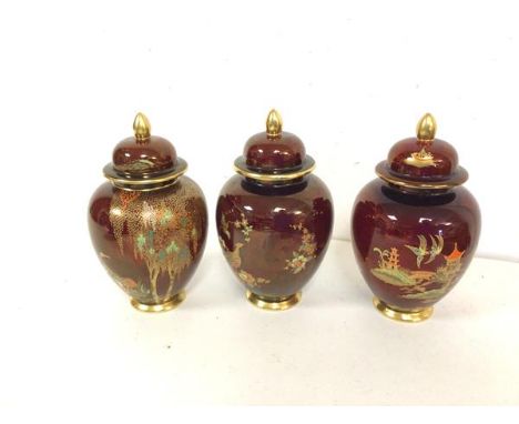 A set of three 1930s/40s Carltonware lidded baluster shaped vases, one stamped Carltonware Handpainted, another Carltonware R
