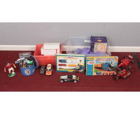 Two boxes of assorted toys - comprising of two Thomas the tank engine clockwork train sets, Honda CBX motorbike and a tin of 