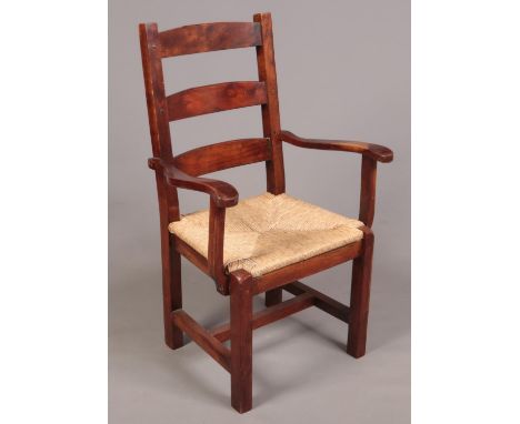 A large mahogany ladder back armchair with rush seat.  