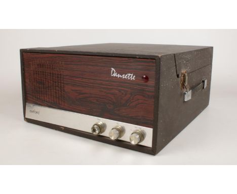 A Dansette Oxford portable record player with Garrard deck. Model no 1025. H: 19cm, W: 38cm, D: 42cm.  Condition fair. Not PA