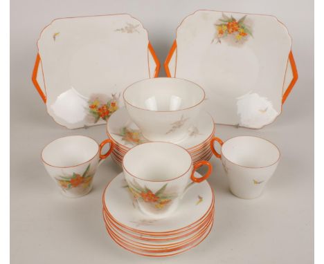 A part Shelly tea service, decorated with flowers and orange border.  Condition good. No chips or cracks, but slight staining