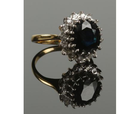 An 18ct gold sapphire and diamond cluster ring. 5.79g. Size I. (Sapphire size 11mm x 9mm).  
