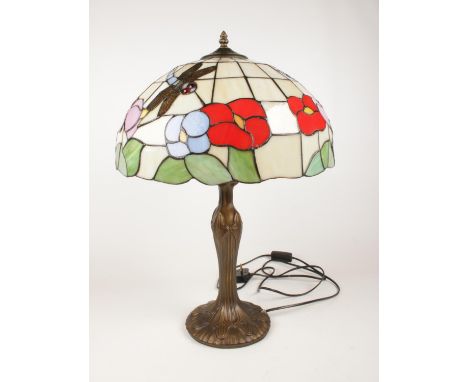 A large tiffany style table lamp with leaded glass shade and metal lamp base. Dragonfly and floral detail to shade. Approx. 6