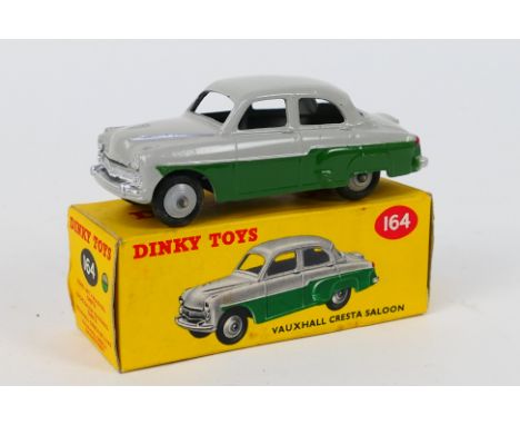 Dinky Toys - A boxed Dinky Toys #164 Vauxhall Cresta Saloon. The model in two tone grey and green with grey hubs, has a few s