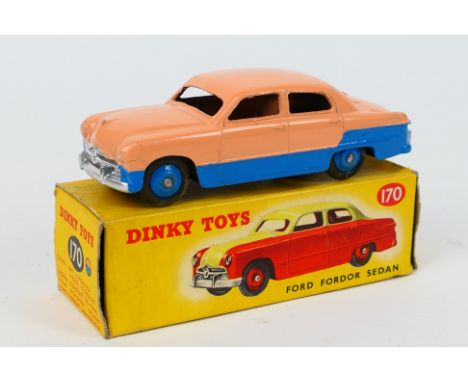 Dinky Toys - A boxed Dinky Toys #170 Ford Fordor Sedan. The model in two tone low line salmon pink and blue, with blue hubs,l