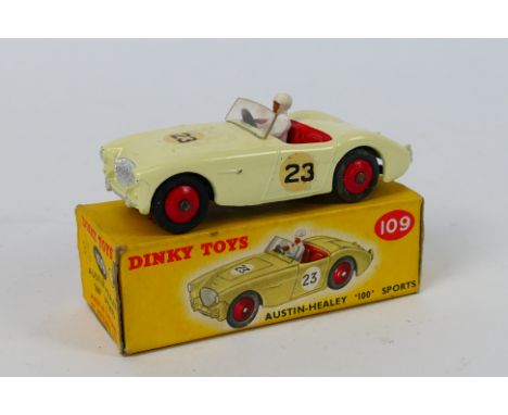 Dinky Toys - A boxed Dinky Toys #109 Austin Healey '100' Sports. The model in off-white, red interior, red hubs, white driver