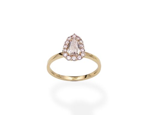 A fancy-coloured diamond ringThe shield-shaped diamond, weighing 0.77 carat, of pink tint, within a surround of brilliant-cut