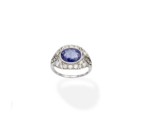 A sapphire and diamond ringThe oval-cut sapphire within an openwork surround, millegrain-set with brilliant and old brilliant