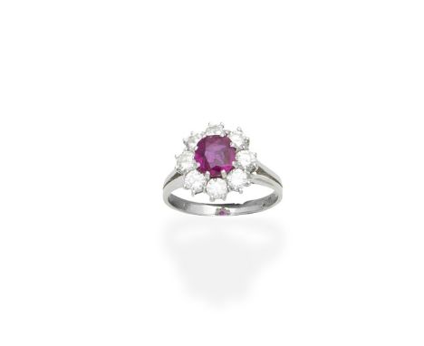 A ruby and diamond cluster ring,  1976The cushion-shaped ruby within a surround of brilliant-cut diamonds, between bifurcated