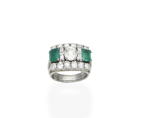 An emerald and diamond ringSet with a central cushion-shaped diamond between step-cut emerald and baguette-cut diamond should