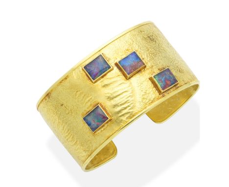 A gold and opal doublet cuff, by Gerald Benney, 1975The textured 18 carat yellow gold cuff set to the front with four rectang