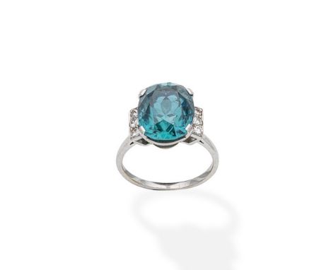 A mid 20th century zircon and diamond dress ringThe cushion-shaped blue zircon between brilliant-cut diamond shoulders,  ring