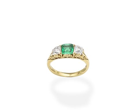 An emerald and diamond three-stone ringThe step-cut emerald between two cushion-shaped diamonds, the gallery and shoulders of