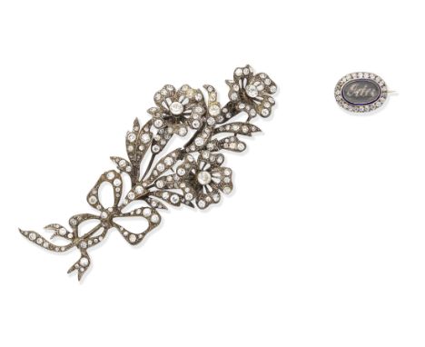 A late 18th century diamond and enamel mourning brooch, and a paste spray brooch1st: The hairwork plaque with the applied nam