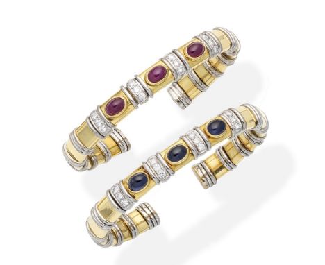 A pair of gem-set banglesEach of sprung form, composed of bicoloured links, set to the front  with oval ruby or sapphire cabo
