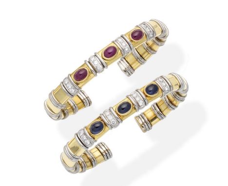 A pair of gem-set banglesEach of sprung form, composed of bicoloured links, set to the front  with oval ruby or sapphire cabo