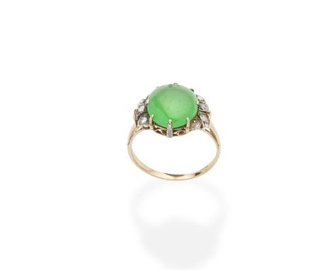 a mid-20th century jade and diamond ringThe oval jade cabochon between bicoloured shoulders set with brilliant-cut diamonds, 