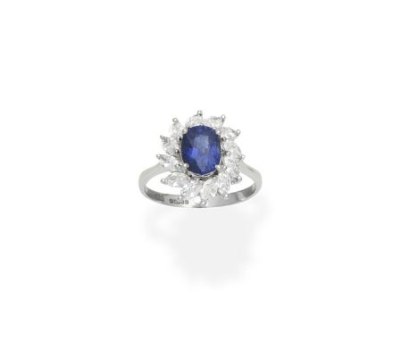 A sapphire and diamond cluster ringThe oval-cut sapphire within a surround of marquise-cut diamonds, mounted in 18 carat whit