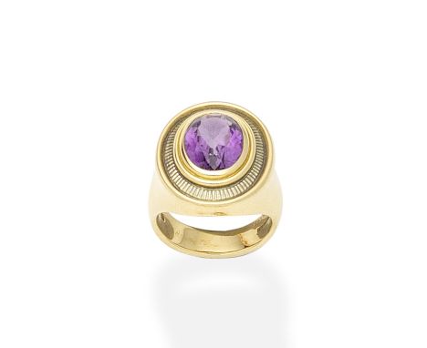 An enamel and amethyst ring, by De Vroomen, 1996The oval-cut amethyst within a grey guilloché enamel surround, in an 18 carat