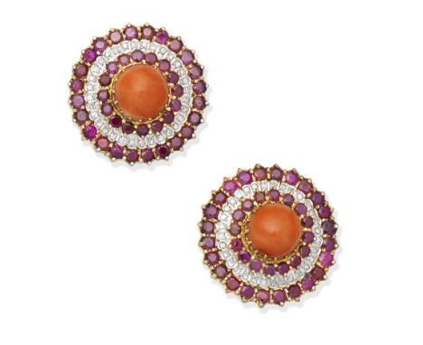 A pair of ruby, coral and diamond earclips, circa 1970Each circular coral corallium rubrum cabochon within a surround of circ