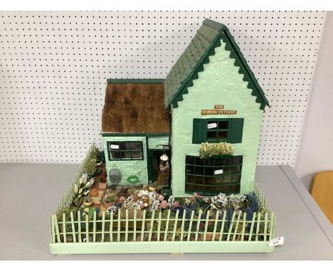 A Highly Detailed "The Garden Cottage" Display Dolls House, built by Pamela Irving; the painted green textured exterior with 