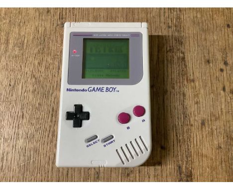 A Nintendo Game Boy Hand Held Gaming Console, S/N G18942466, Owners Manual, Four Games Cartridges including Tetris, Paperboy,