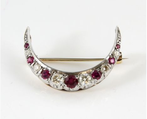 Ruby and diamond crescent brooch, set with round brilliant cut diamonds, estimated total diamond weight 0.56 carats, alternat