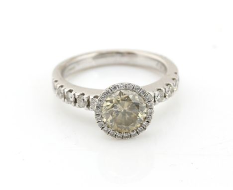 Modern diamond ring, central champagne coloured round brilliant cut diamond, surrounded by white round brilliant cut stones a