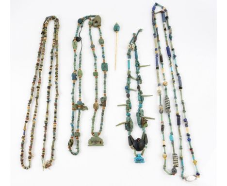 Ancient Egyptian jewellery, four glasswork and hard stone bead necklace with amulets, and scarab stick pin, in 15 ct Provenan