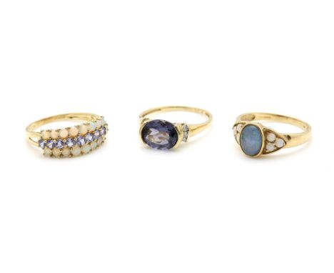 A gold ring set with faceted tanzanite, an opal and tanzanite ring, and a opal doublet set ring, all 9 ct ring size T .   Gro