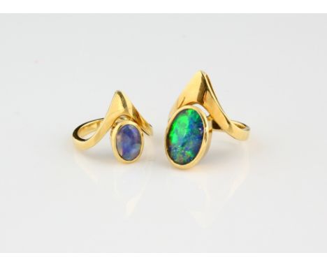 Contemporary opal triplet ring, rub over set above a wishbone band, and similar smaller ring, both size M and in yellow metal