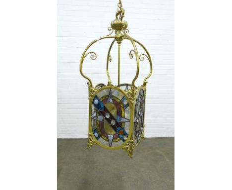 A large brass hanging lantern light,  with stained glass panels, 31 x 76cm.