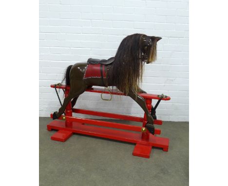 Childs rocking horse, on a red painted trestle rocking base, 122 x 100cm.