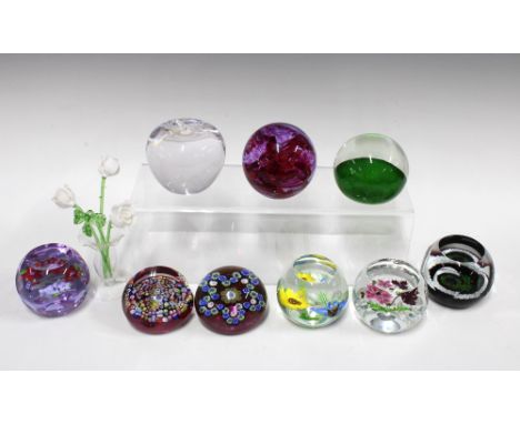 Collection of paperweights, including a Caithness Scotland Christmas paperweight, three Caithness floral paperweights, Caithn