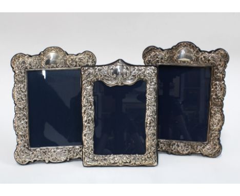 Pair of white metal photograph frames, 15 x 21cm, together with a Sheffield silver photograph frame (3)