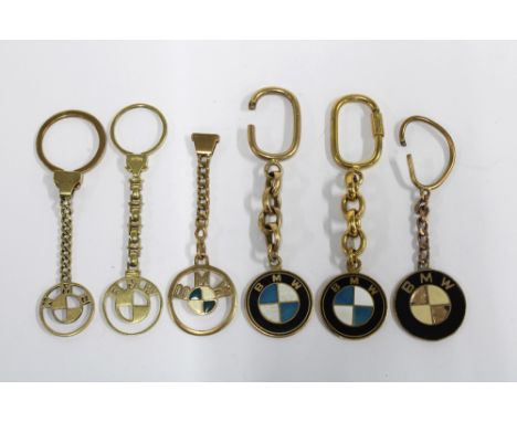 Six BMW keychains, three of which are stamped 14kt on the clasps only and one stamped 375 on the clasps only, the two others 