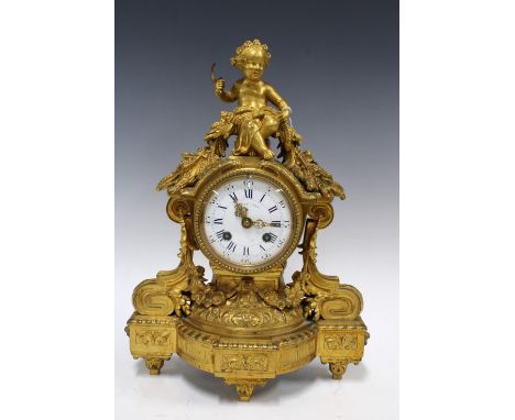 French gilt bronze mantel clock, the case surmounted by a putto with scythe and wheat sheafs, on three pointed feet, brass mo